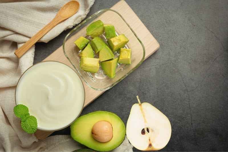 A creamy green avocado and pear smoothie in a glass jar, perfect for toddlers.