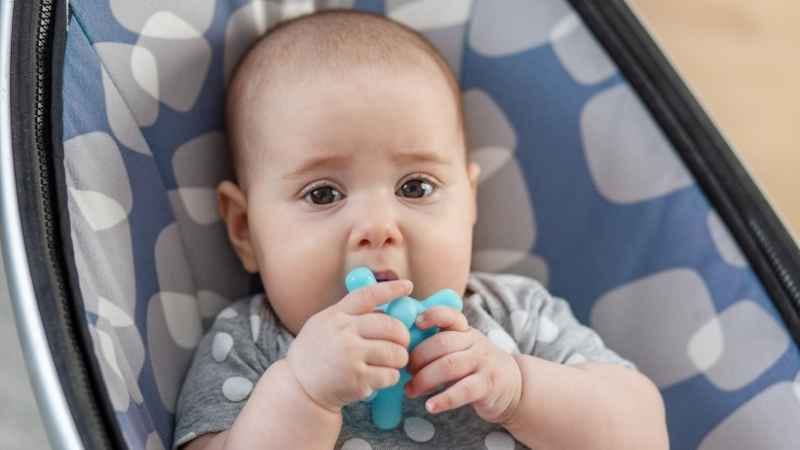 Baby chewing on colorful Silicone Teething Toys to soothe sore gums during teething time.