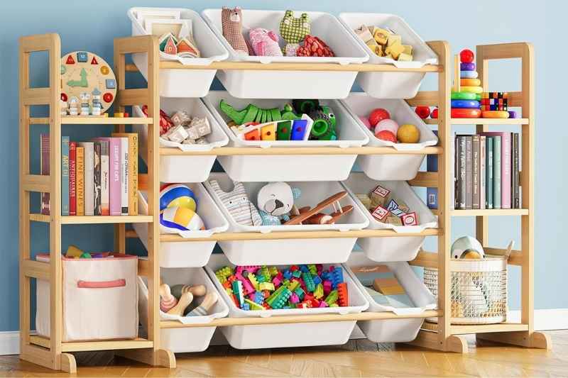 White wooden toy storage with 6 shelves and 12 bins neatly organizing plush toys for kids’ playrooms.